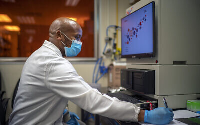 Sandile Cele, a researcher at the Africa Health Research Institute in Durban, South Africa, works on the omicron variant of the COVID-19 virus, Dec. 15, 2021 (AP Photo/Jerome Delay)