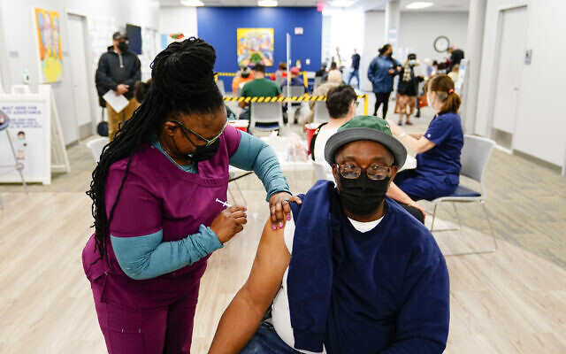 Nurse Sheena Davis administers a dose of a Moderna COVID-19 vaccine during a vaccination clinic at the Keystone First Wellness Center in Chester, Pennsylvania, Dec. 15, 2021. (AP Photo/Matt Rourke)