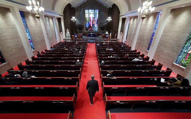 Rev. Meredith Mills delivers a sermon from the pulpit for some 30 attendants during the second service of the day in the sanctuary at Westminster United Methodist Church in Houston, Texas, Dec. 12, 2021. (Michael Wyke/AP)