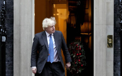 Britain's Prime Minister Boris Johnson steps out of 10 Downing Street to welcome the Sultan of Oman, Haitham Bin Tarik Al Said, in London, December 16, 2021. (AP Photo/Frank Augstein)