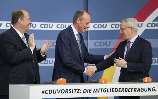 From left, candidate Helge Braun, new elected party chairman Friedrich Merz and candidate Norbert Roettgen, attend a press conference of the German Christian Democratic Party (CDU) at the party's headquarters in Berlin, Germany, December 17, 2021 to announce the results of a ballot on who will become its new leader. (AP Photo/Michael Sohn)