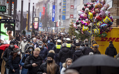 Despite rainy weather, Duesseldorf's city center is well frequented despite the coronavirus rules for retailers, shortly before Christmas in Duesseldorf, Germany, on Saturday, December 18, 2021. (Malte Krudewig/dpa via AP)