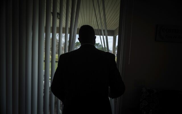 Joseph Moore looks out of a window at his home in Jacksonville, Florida, on Tuesday, Dec. 7, 2021 (AP Photo/Robert Bumsted)