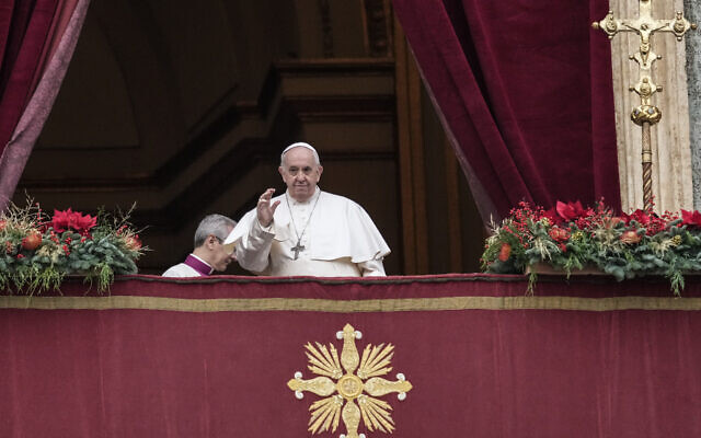 Pope Francis looks at the crowd before delivering the Urbi et Orbi (Latin for 'to the city and to the world') Christmas' day blessing from the main balcony of St. Peter's Basilica at the Vatican, on December 25, 2021. (AP Photo/Gregorio Borgia)