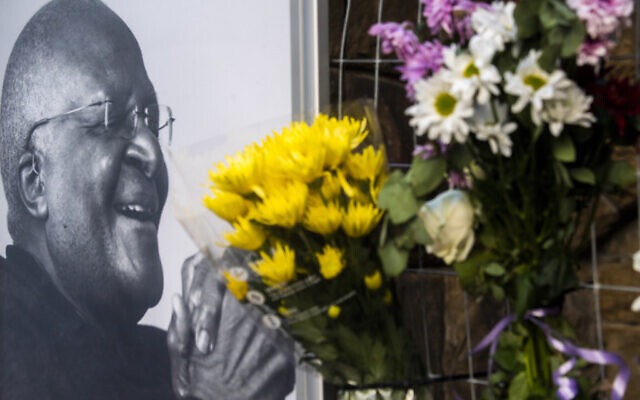 Flowers are placed alongside a photo of Anglican Archbishop Desmond Tutu at the St. George's Cathedral in Cape Town, South Africa, December 26, 2021. (AP Photo)