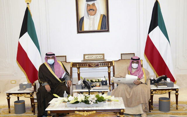 In this photo released by Kuwait News Agency, KUNA, Emir of Kuwait, Sheikh Nawaf Al Ahmad Al Sabah, right, receives Prime Minister, Sheikh Sabah Al-Khaled Al Hamad Al Sabah, in Kuwait, Tuesday, Dec. 28, 2021. ( KUNA via AP)