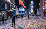 Jaclyn Bernstein of New York stands in confetti, among the few to observe the Times Square New Year's Eve ball drop early Friday, Jan. 1, 2021. (AP/Craig Ruttle)