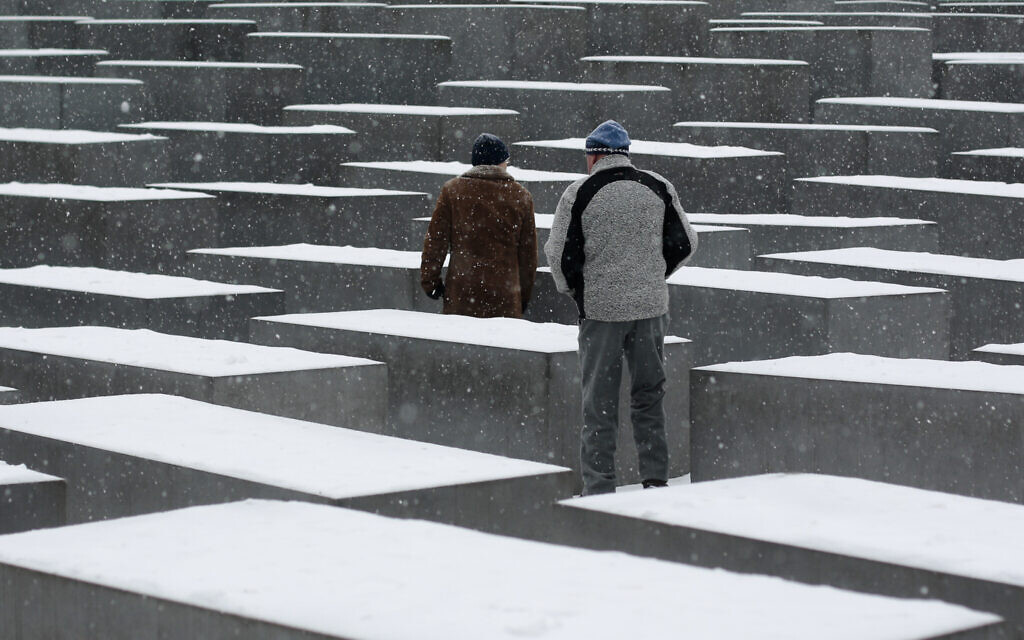 Illustrative: Two men visit the snow covered Holocaust Memorial at the International Holocaust Remembrance Day in Berlin, January 27, 2014. (AP Photo/ Markus Schreiber/ File)