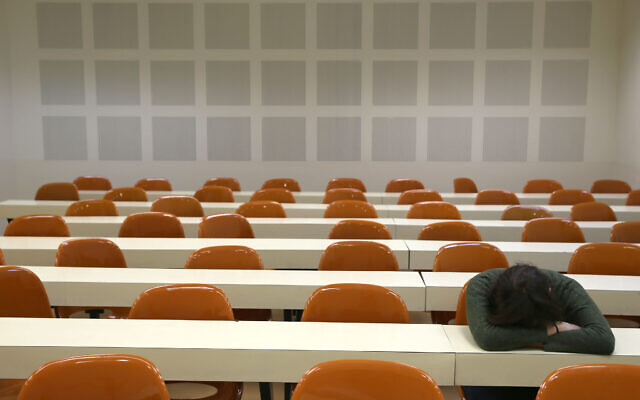 Illustrative: A young student sits with her head down in an empty classroom. (Nati Shohat/Flash 90)