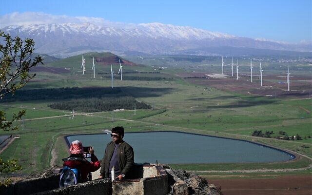 People visit at a lookout point on Mount Bental, overlooking the border with Syria, in the Golan Heights, on March 12, 2021. (Michael Giladi/Flash90)