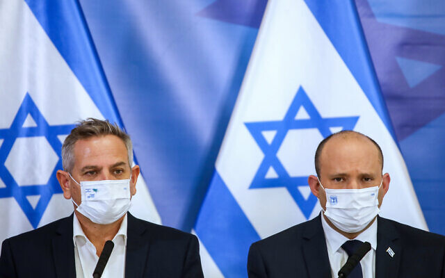 Illustrative: Prime Minister Naftali Bennett, right, and Health Minister Nitzan Horowitz hold a press conference at the HaKirya military base in Tel Aviv, November 26, 2021. (Moti Milrod)