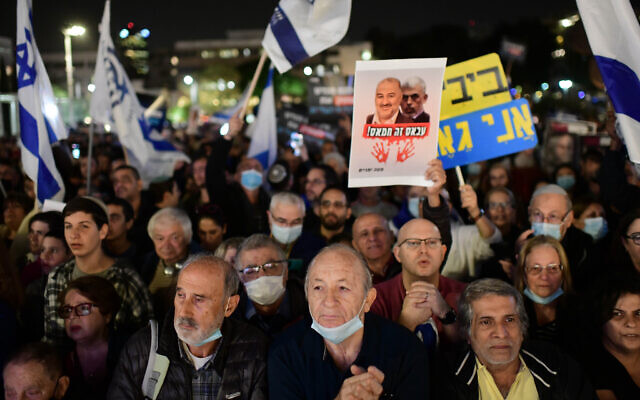 Right-wing activists and Likud supporters protest against the Israeli government in Tel Aviv, December 7, 2021. The sign reads Abbas is Hamas.(Tomer Neuberg/Flash90)