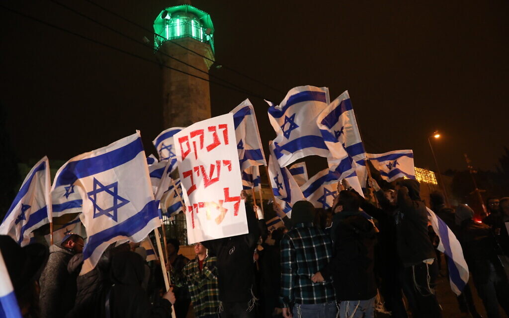 Several dozen far-right Jewish nationalists march through the East Jerusalem neighborhood of Sheikh Jarrah, in response to a suspected Palestinian terror attack against an Israeli Jewish resident there earlier in the day, December 8, 2021. (Noam Revkin Fenton/Flash90)