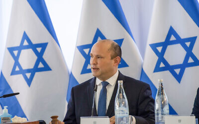 Prime Minister Naftali Bennett leads a cabinet meeting in Kibbutz Mevo Hama on December 26, 2021. (Gil Eliyahu/POOL/Flash90)