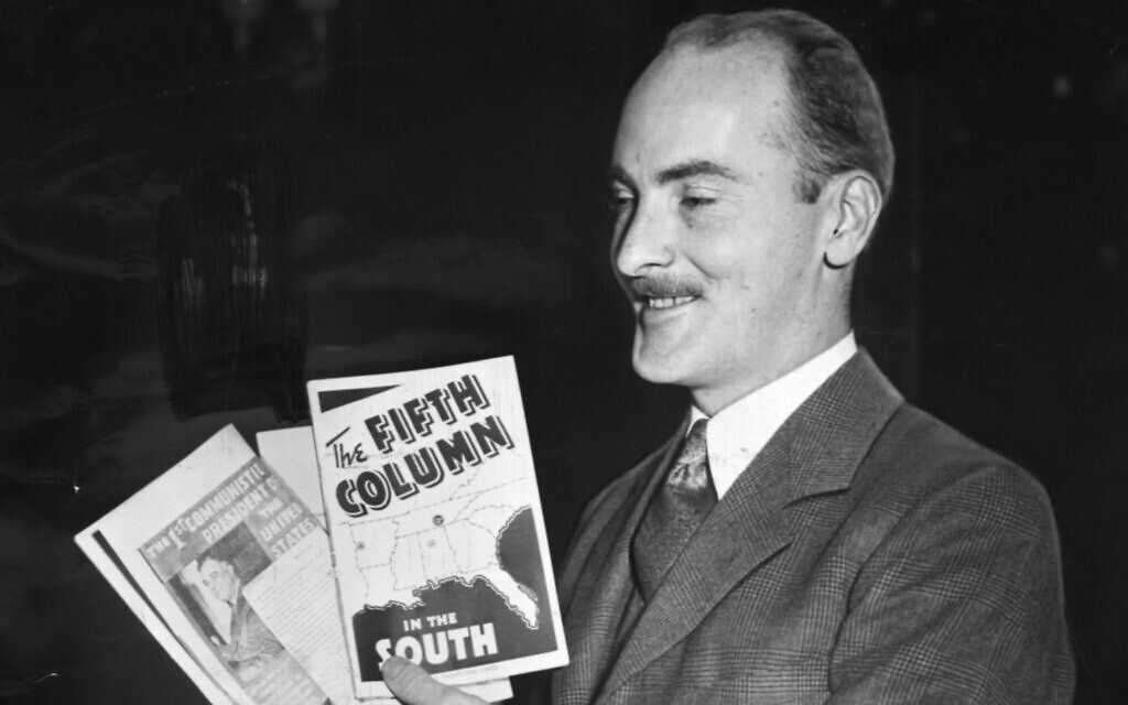 Boston Christian Front leader Francis Moran shows off the group’s pamphlets. In January 1942 police seized these and other materials from Hibernian Hall in Roxbury. (Photo Credit: Boston Herald- Traveler Photo Morgue/ Boston Public Library/ Courtesy of Harvard University Press)