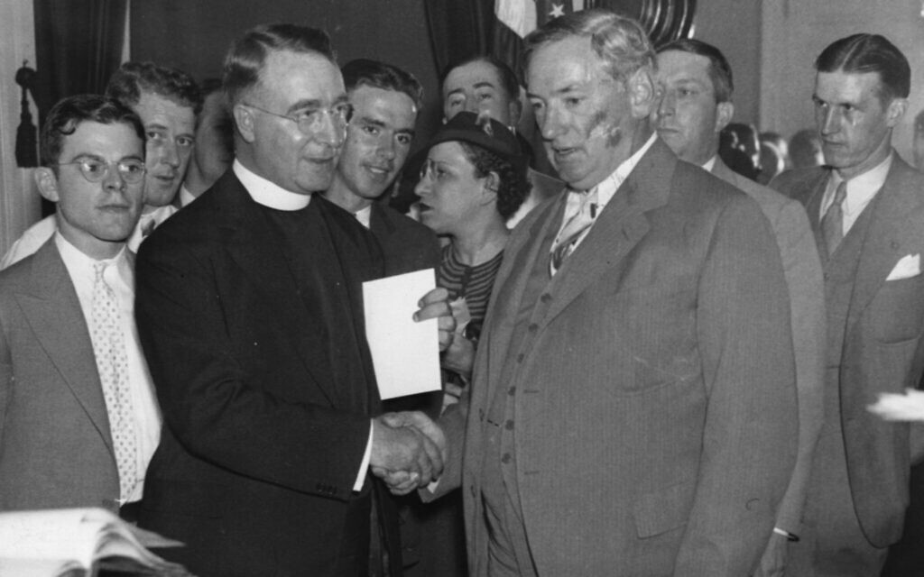 Father Charles Coughlin shakes hands with Massachusetts Governor James Michael Curley at the State House, Boston, on August 13, 1935. (Photo Credit: Boston Herald- Traveler Photo Morgue/ Boston Public Library/ Courtesy of Harvard University Press)