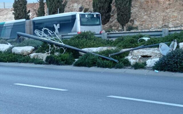 An electricity pylon in Jerusalem was knocked downed by stormy weather, hitting a truck and injuring two, December 20, 2021. (Magen David Adom)