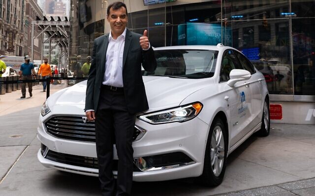 Professor Amnon Shashua, Intel senior vice president and president and CEO of Mobileye, stands with a self-driving vehicle from Mobileye’s autonomous test fleet, during an event at Nasdaq in New York City in 2021. (Mobileye, an Intel Company)