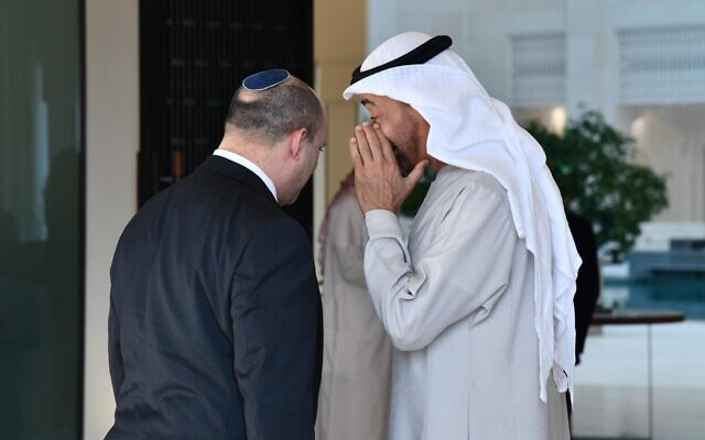 UAE Crown Prince Sheikh Mohammed bin Zayed whispers to Prime Minister Naftali Bennett in Abu Dhabi, on December 13, 2021. (Haim Zach/GPO)