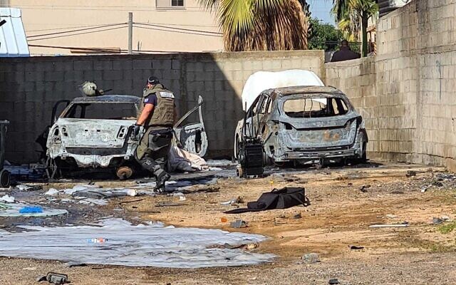 The scene of a deadly incident when a bomb exploded, destroying a car and killing a woman sitting inside, in Ramle December 26, 2021. (Israel Police)