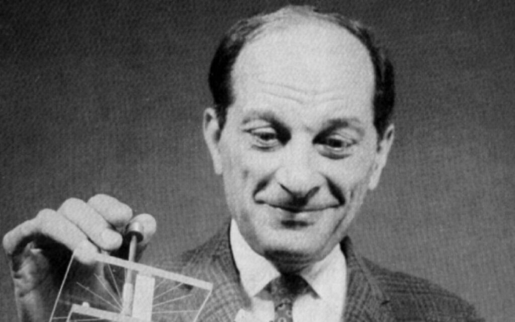 Stan Ulam holding the FERMIAC, an analog computer invented by his colleague Enrico Fermi. (Public domain)