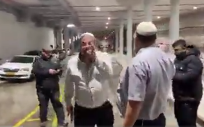 Screen capture from video of MK Itamar Ben Gvir, with a pistol in his right hand, during an altercation with Arab security guards at the Expo Tel Aviv conference center, December 21, 2021. (Twitter)