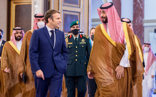 Saudi Crown Prince Mohammed bin Salman (right) greets French President Emmanuel Macron (left) upon his arrival in Jiddah, Saudi Arabia, on December 4, 2021. (Bandar Aljaloud/Saudi Royal Palace via AP)