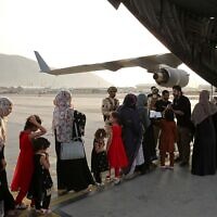 Afghans board a Qatari transport plane  to leave the country in Kabul, Afghanistan, August, 18, 2021. (Qatar Government Communications Office via AP)