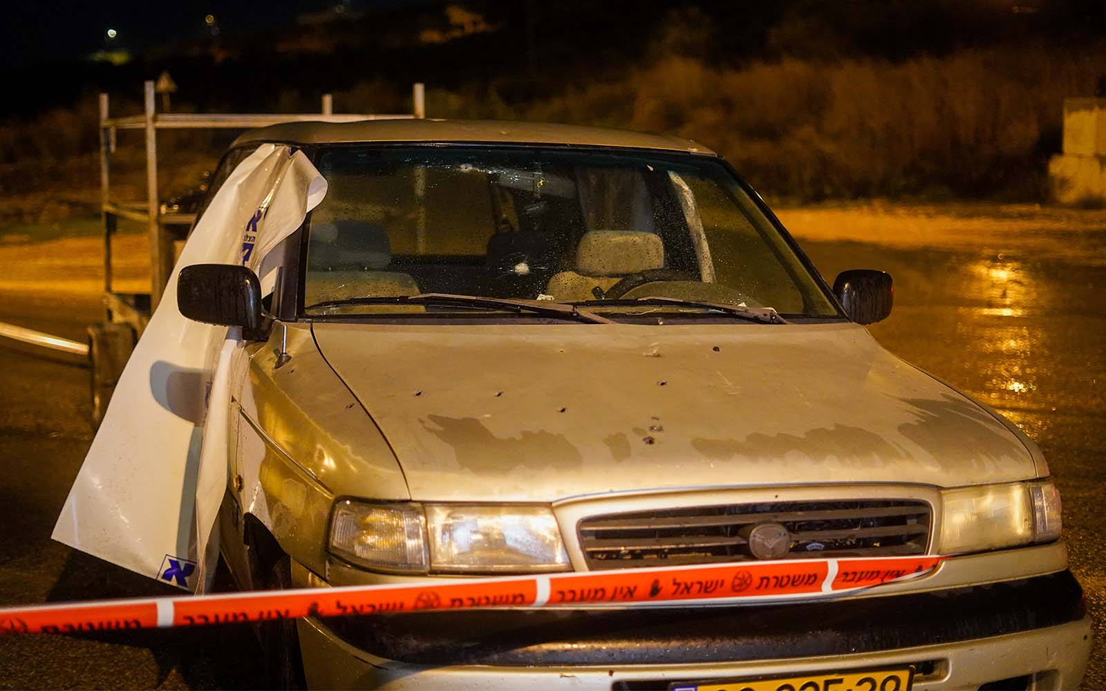 The vehicle that was fired on in a terror attack near the Homesh outpost in the West Bank, December 16, 2021. (Hillel Maeir/Flash90)