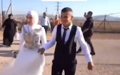 Screen capture from video showing a Palestinian bride and groom crossing into Israel through a gap in the West Bank security fence. (Twitter)