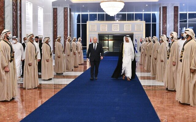 Prime Minister Naftali Bennett walks with UAE Foreign Minister Abdullah bin Zayed in Abu Dhabi on December 12, 2021. (Haim Zach/GPO)