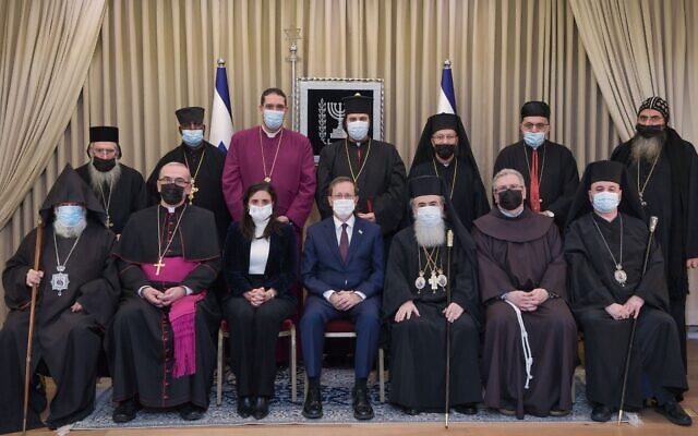 President Isaac Herzog and Interior Minister Ayelet Shaked (center) pose for a photo with church leaders in Jerusalem on December 29, 2021. (Kobi Gideon/GPO)