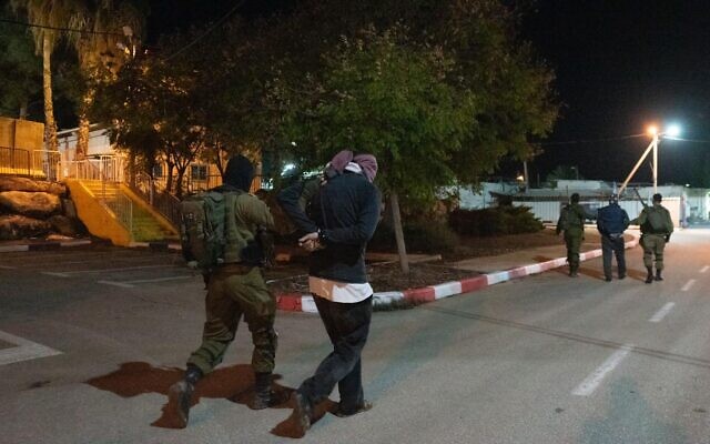Israeli special forces arrest two men suspected of being part of the cell that carried out a deadly shooting attack outside the illegal Horesh outpost in the West Bank, on December 19, 2021. (Israel Defense Forces)