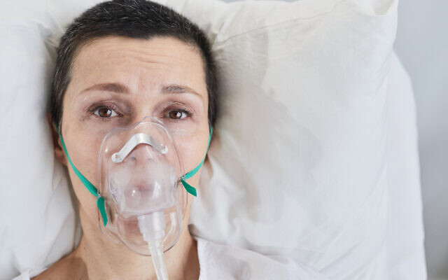 A woman in bed with an oxygen mask (iStock via Getty Images)