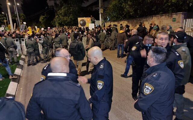 Police officers secure an anti-vaccination protest in Ra'anana, on December 18, 2021. (Israel Police)