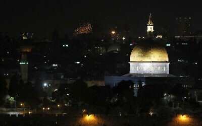 Fireworks explode over Jerusalem's Old City during New Year's Eve celebrations, on December 31, 2021 (Photo by AHMAD GHARABLI / AFP)