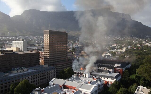 A general view of a building on fire at the South African Parliament precinct in Cape Town on January 2, 2022. (Obed Zilwa / AFP)