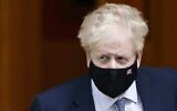 Britain's Prime Minister Boris Johnson, wearing a face covering to help mitigate the spread of COVID-19, leaves from 10 Downing Street in central London on January 12, 2022.(Tolga Akmen/AFP)