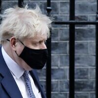 Britain's Prime Minister Boris Johnson leaves from 10 Downing Street in central London on January 12, 2022. (Tolga Akmen / AFP)