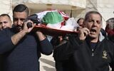 Palestinian relatives carry the body of Omar As'ad, at his funeral; As'ad was found dead after being detained and handcuffed during an Israeli raid, in Jiljilya village in the West Bank, on January 13, 2022. (JAAFAR ASHTIYEH / AFP)