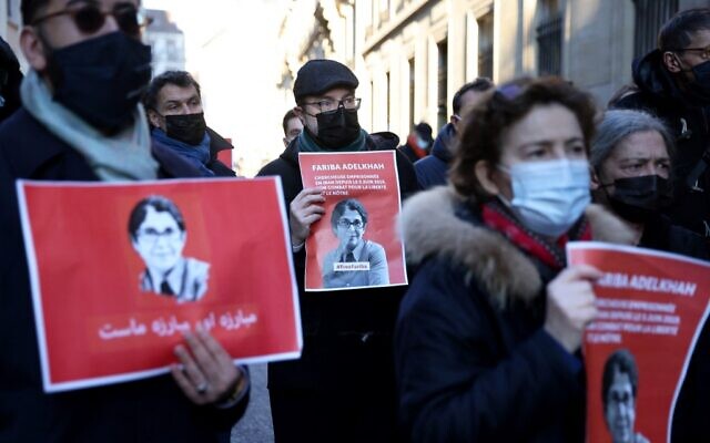 Colleagues of French-Iranian academic Fariba Adelkhah hold placards depicting her as they gather in Paris on January 13, 2022, in order to support her following the decision of the Iranian government to send her back to prison after a period of house arrest. (Thomas COEX / AFP)