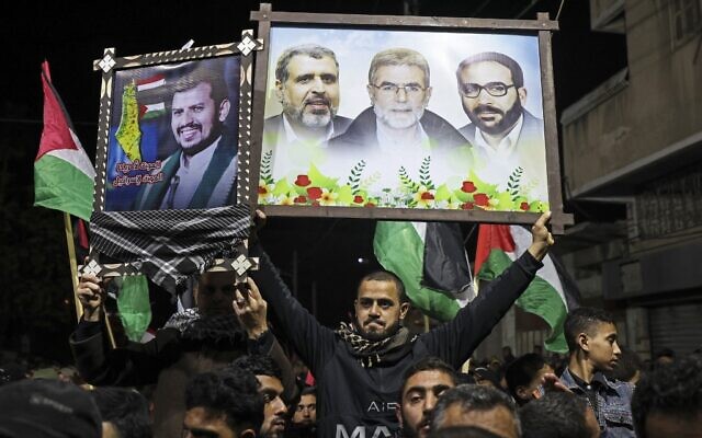 Palestinian Islamic Jihad supporters lift placards as they demonstrate in Gaza city on January 22, 2022, to denounce the war in Yemen. The portraits depict (L to R) Yemen's Houthi rebel leader Abdul-Malik al-Huthi, Palestinian Islamic Jihad group's late leader Ramadan Shalah, current Secretary-General Ziad al-Nakhala, and late leader Fathi Shaqaqi. (Mahmud HAMS / AFP)