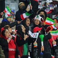 Female supporters of Iran's national soccer team cheer during the 2022 Qatar World Cup Asian Qualifiers match between Iran and Iraq, at the Azadi Sports Complex in the capital Tehran, on January 27, 2022. (Atta Kenare/AFP)