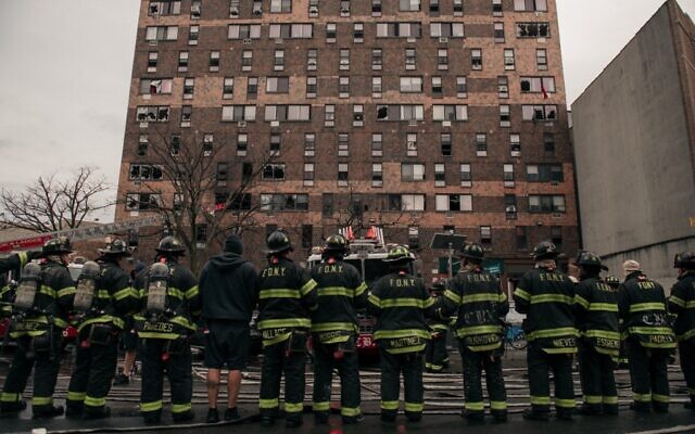 Emergency first responders remain at the scene after an intense fire at a 19-story residential building that erupted in the morning of January 9, 2022 in the Bronx borough of New York City. (Scott Heins/ Getty Images/ AFP)