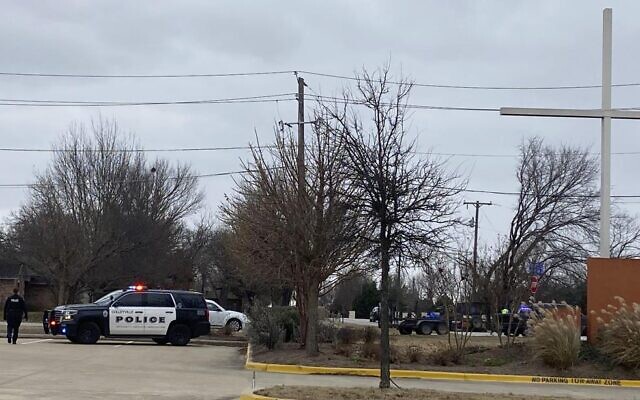 Colleyville police secure the area around Congregation Beth Israel synagogue on Saturday, Jan. 15, 2022 in Colleyville, Texas. Authorities say a man has apparently taken hostages at the synagogue near Fort Worth, Texas (Jessika Harkay/Star-Telegram via AP)