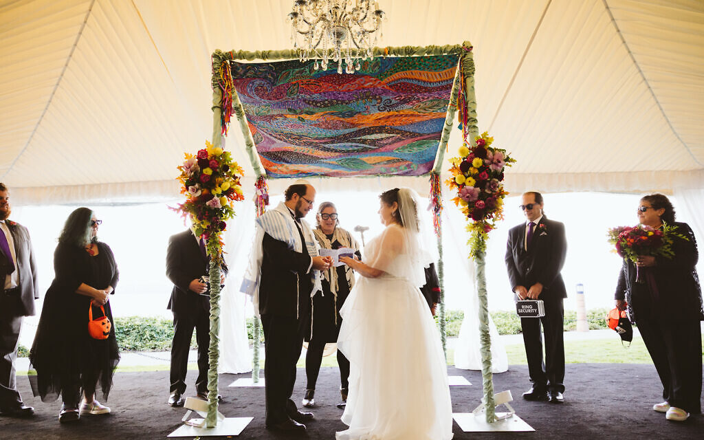 Ben and Julie Schreiber were married October 10, 2021, in Kirkland, Washington, under a huppah whose design incorporated blessings from their friends and wedding guests. (JennyGG Photography/ via JTA)