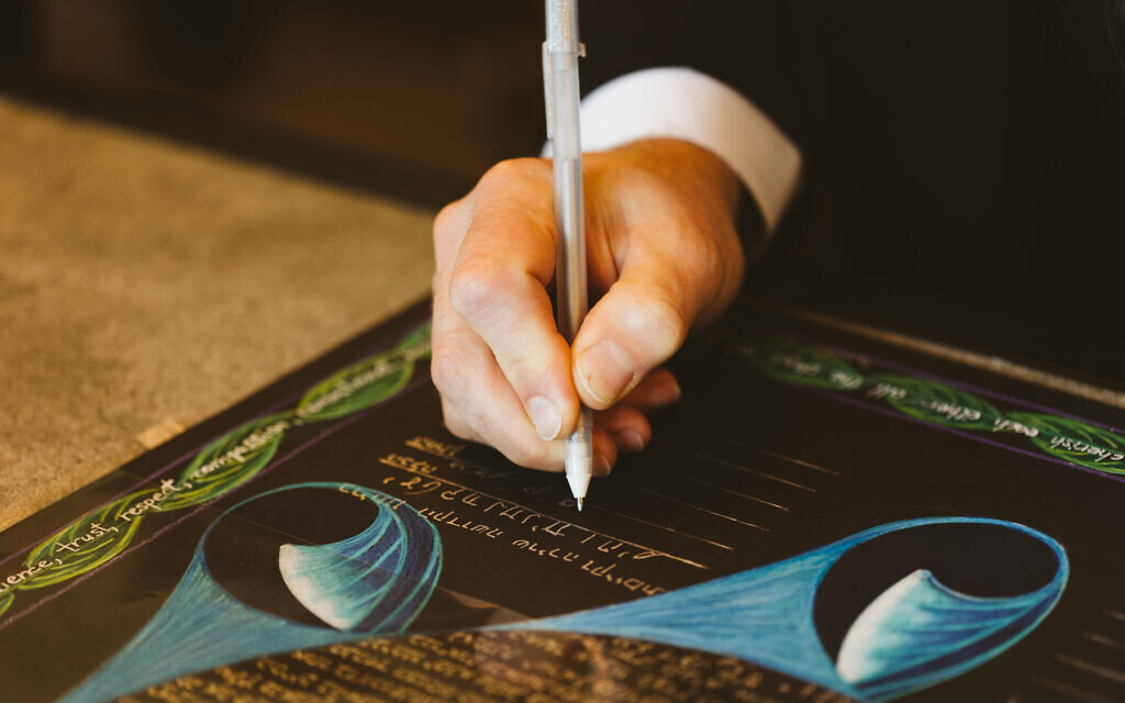 Ben and Julie Schreiber's ketubah was hand-painted with designs inspired by themes from their guests' blessings. (JennyGG Photography/ via JTA)