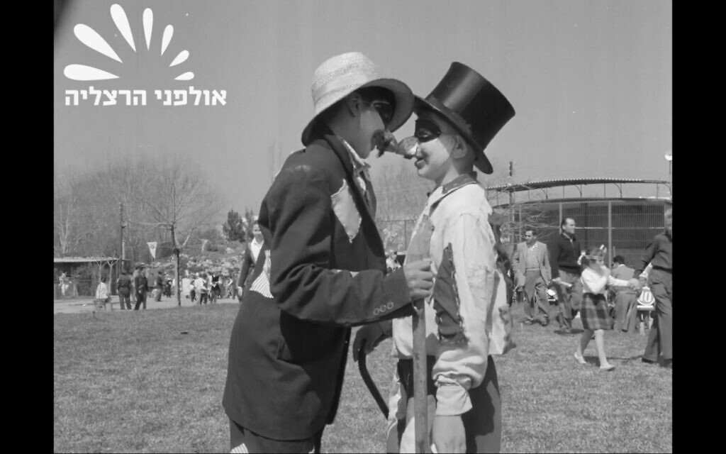 Two Israeli children celebrate Purim at the Tel Aviv Zoo in 1959, in documentary footage available at the Israel Film Archive. (Screenshot from Herzliya Studios Archive/via JTA)