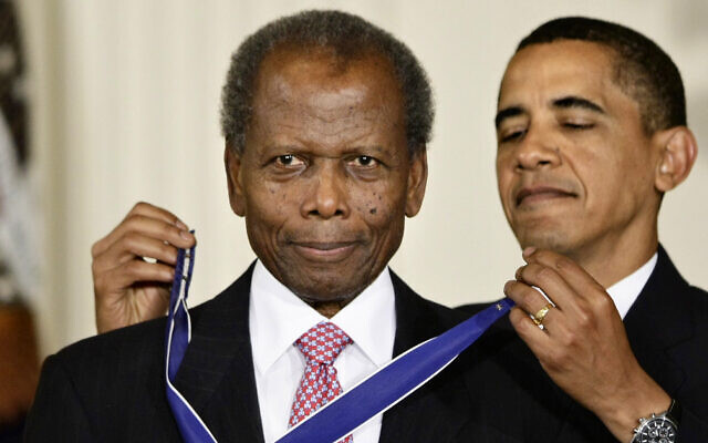 Then US President Barack Obama presents the 2009 Presidential Medal of Freedom to Sidney Poitier during ceremonies in the East Room at the White House in Washington on, Aug. 12, 2009. (AP Photo/J. Scott Applewhite, File)