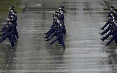 Hong Kong police show their new goose step marching style on the National Security Education Day at a police school in Hong Kong Thursday, April 15, 2021.  (AP Photo/Vincent Yu)